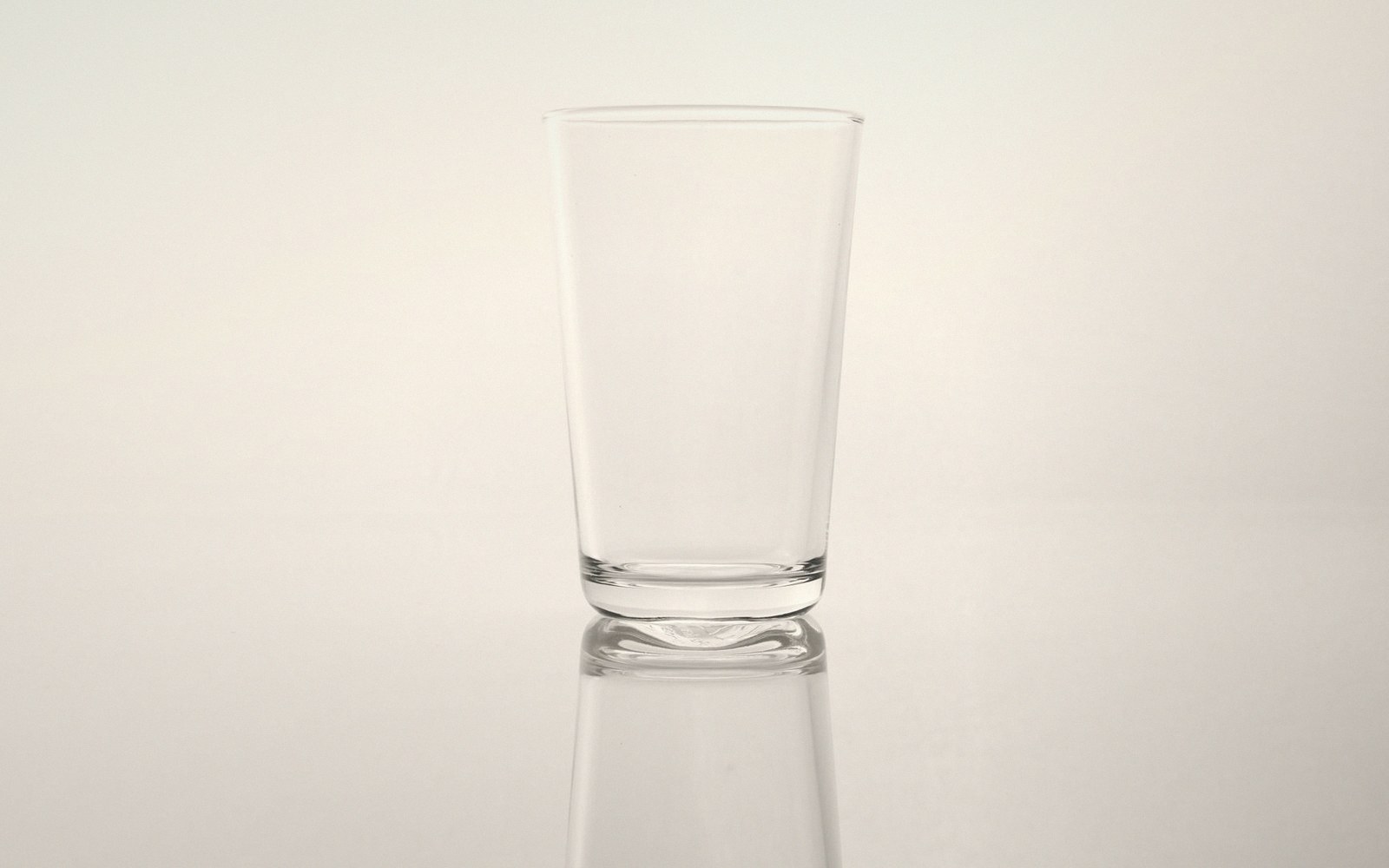 A blown glass vessel against a plain ground
