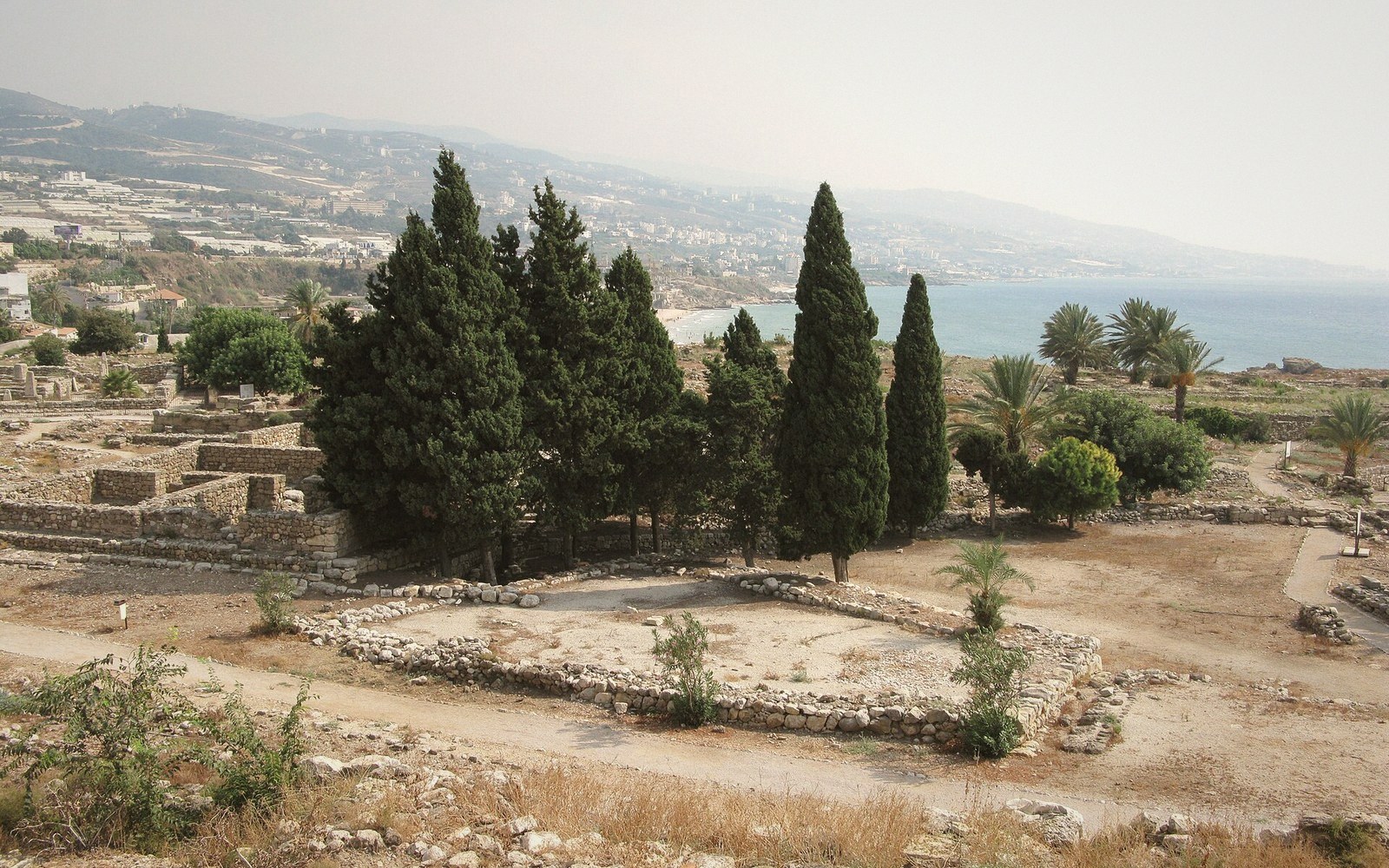 Ancient stone ruins and cypress trees overlook the coastline at Byblos